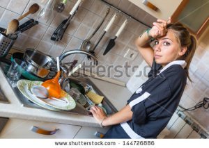 stock-photo-housemaid-washing-dishes-in-the-kitchen-144726886